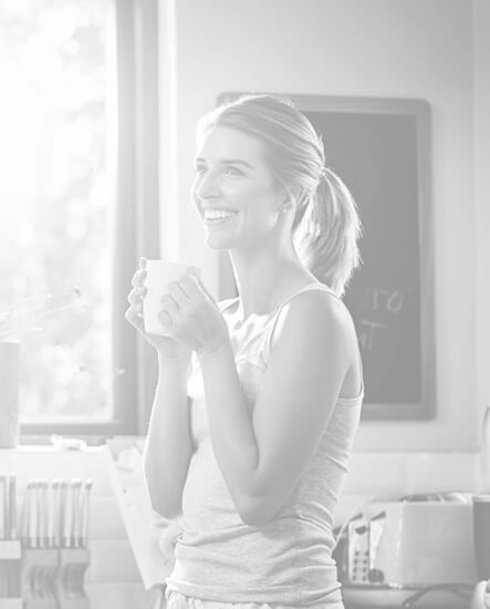Woman smiling while drinking coffee