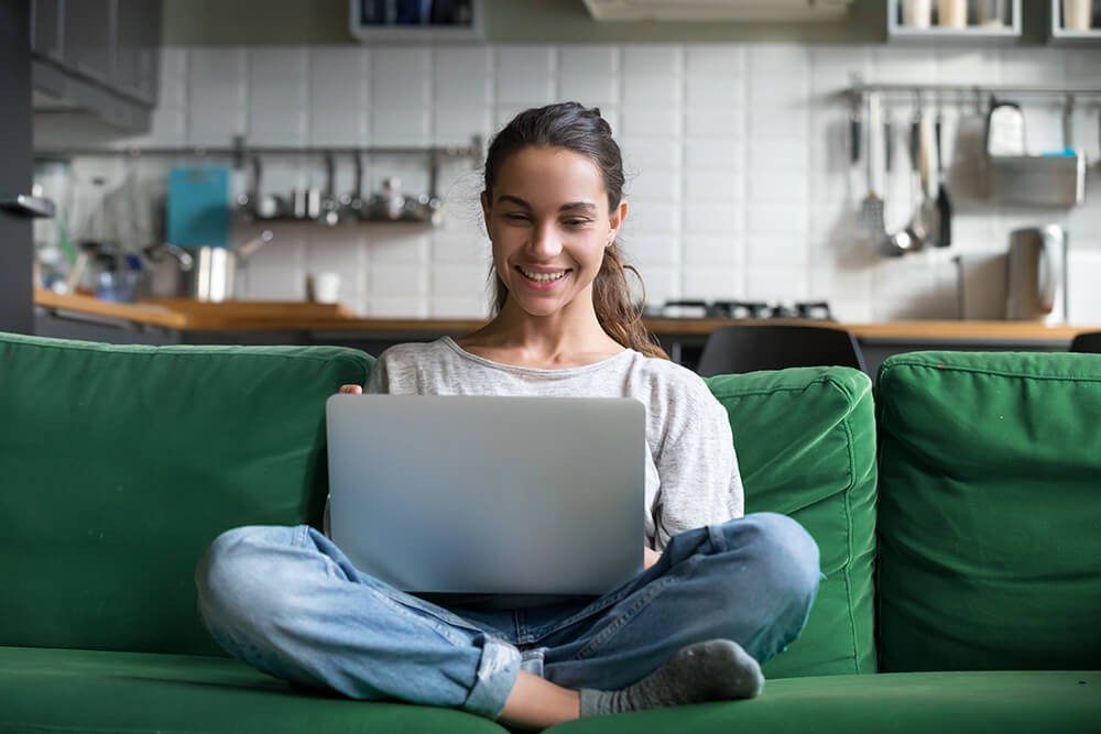 Woman Using Her Laptop Computer on a Couch